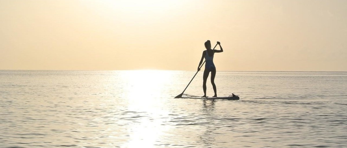 a man standing next to a body of water