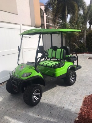 a green motorcycle parked on a sidewalk