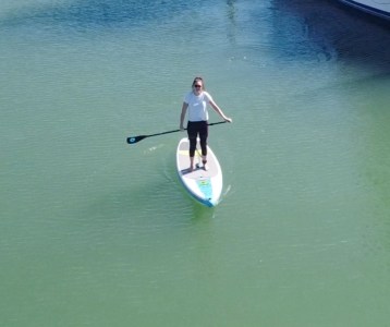 a person riding a surf board on a body of water