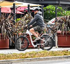 a man riding on the back of a bicycle