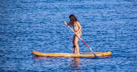 a person riding a surf board on a body of water